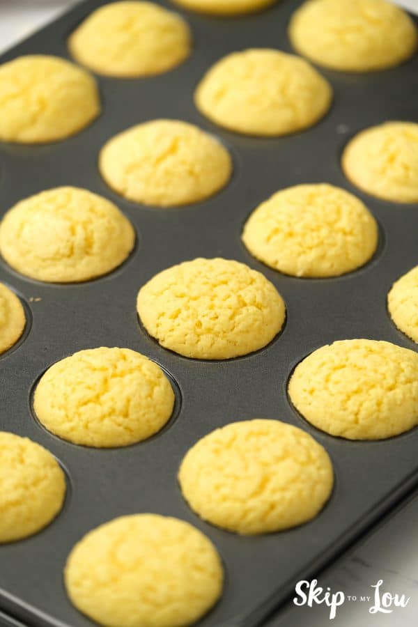 13 baked sugar cookies sitting in a mini muffin tin, by Skip to my Lou.