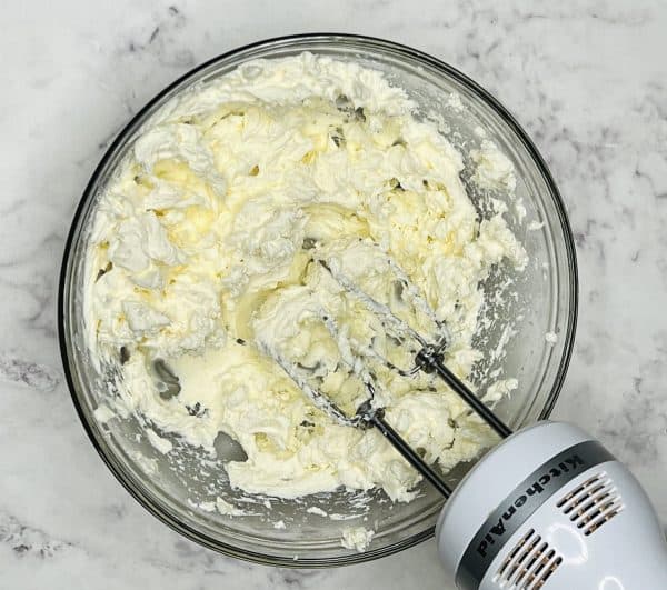 fluffy cheesecake mixture with hand mixer 
