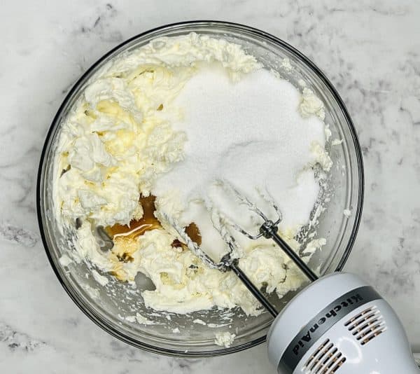 mini cheesecake tart mixture with vanilla and sugar on top