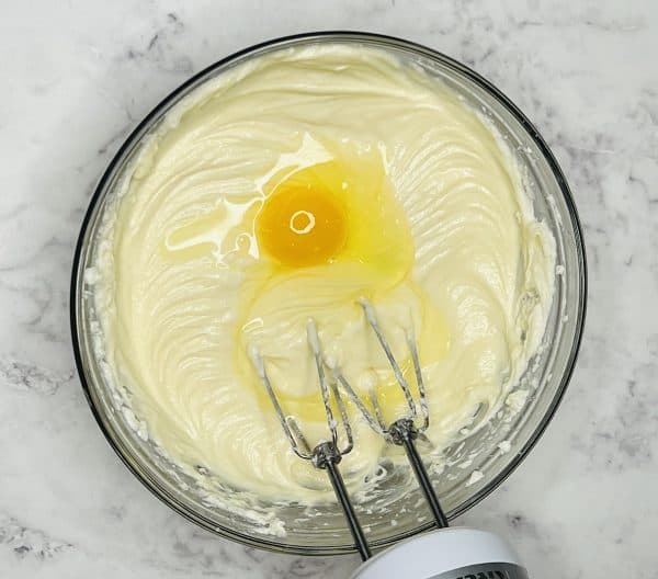 mini cheesecake mixture with an egg on top
