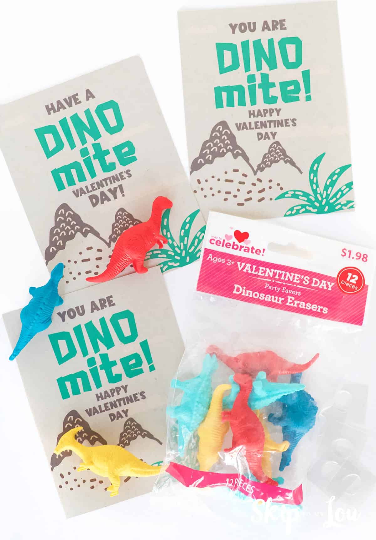 Red and white package of 12 dinosaur shaped erasers in yellow, red, light blue and dark blue. Three cards with dinosaur Valentine messages, by Skip to my Lou.