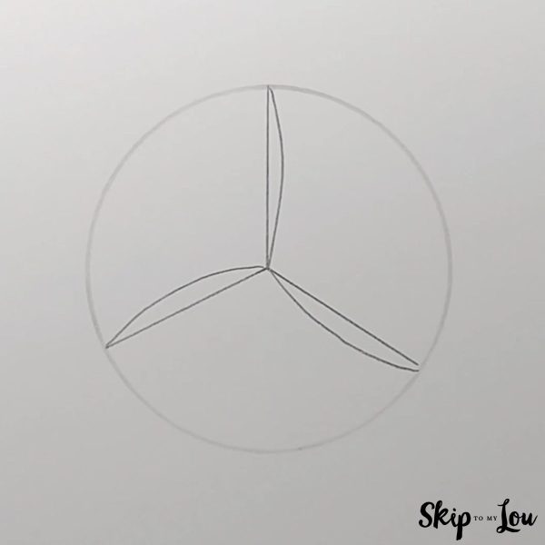 Step two to draw a volleyball is drawing curved lines from the center. - Skip to my lou