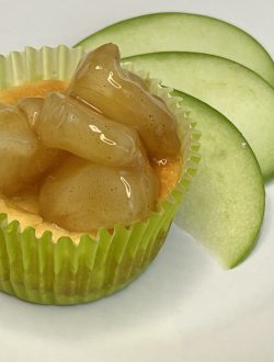 mini apple cheesecake next to fresh green apple slices