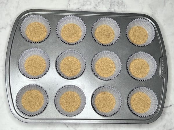 layer of graham cracker crumbs for mini blueberry cheesecake crust