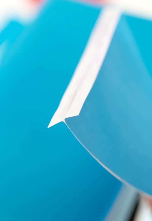 Upclose look at the blue paper shark fin and the folds to make so it can be glued to the shoebox by Skip to my Lou.