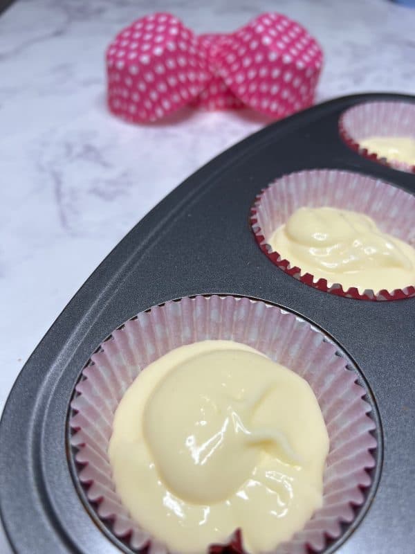 mini strawberry cheesecake mixture in a layer on top of graham crackers