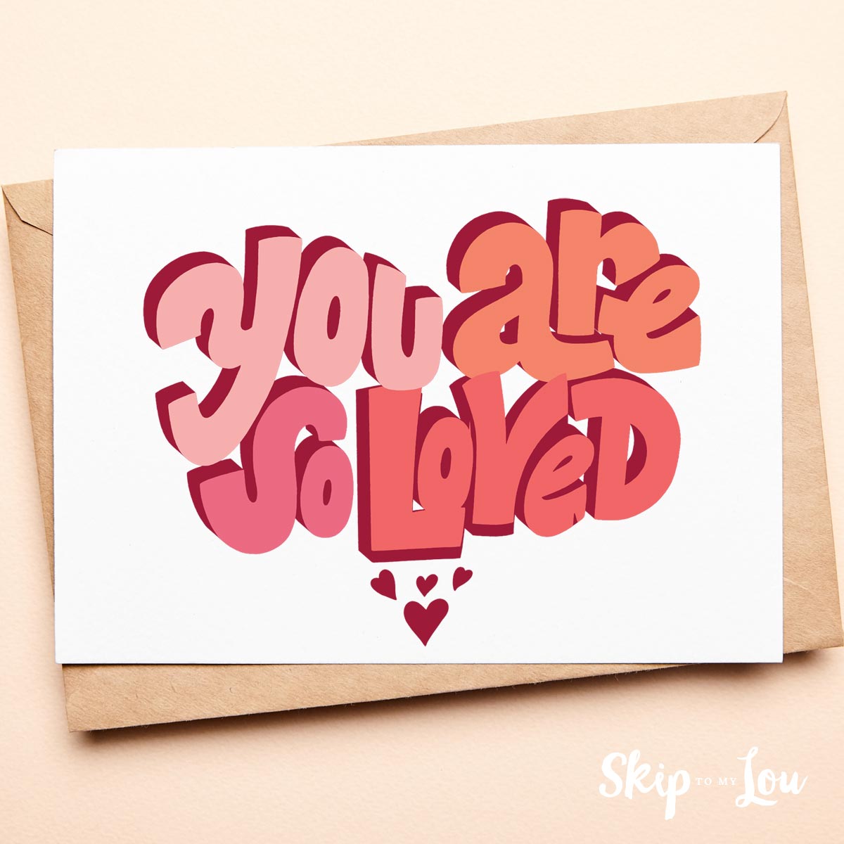 you are so loved printable greeting card with kraft colored envelope on peach background