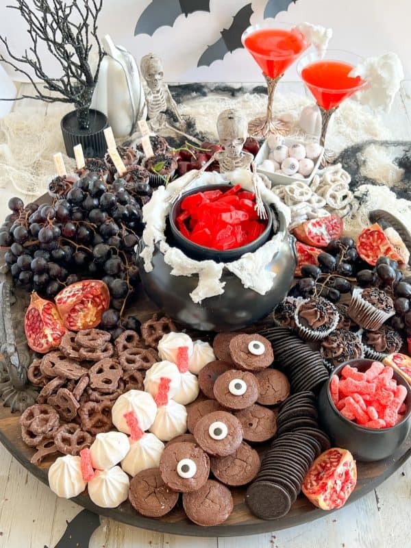 a new dawnn-halloween dessert board with cupcakes, muffins, and candy.