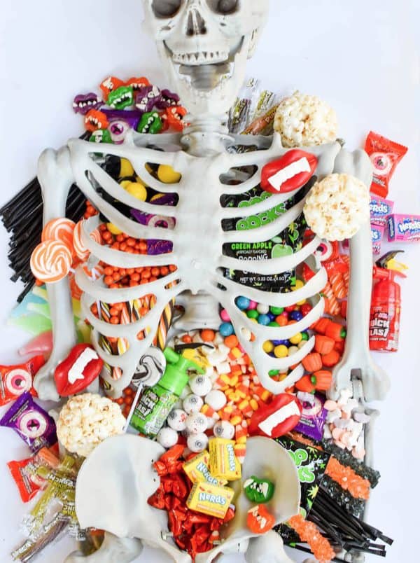 fun 365-a plastic skeleton filled with different halloween candy and treats.