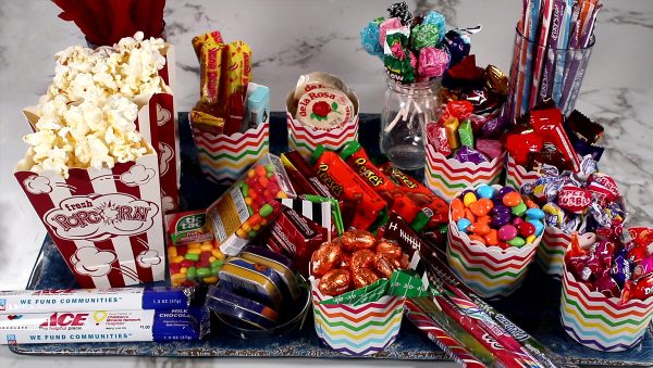 jandatri- candy charcuterie board ideas-movie board with poporn and cups of candy