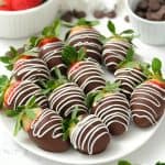 chocolate covered strawberries on a white plate