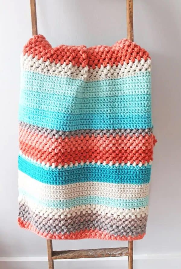Colorful blanket hanging from a wall.