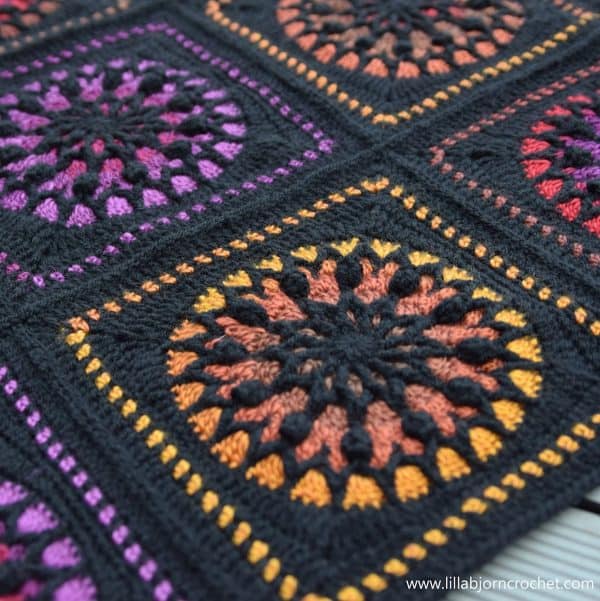 Closeup of a blanket pattern that looks like stained glass.