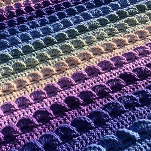 Wavy pattern blanket in pink and purple hues