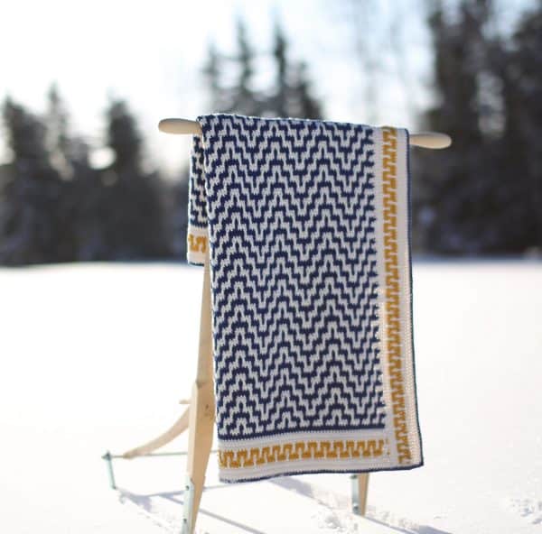 Crochet blanket displayed outdoors