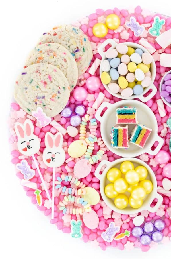 A pink themed Easter candy char charcuterie  board with other sweet Easter treats from Cutefetti.
