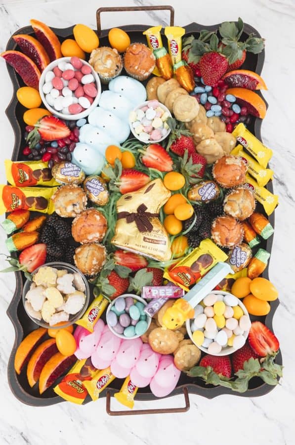 A fruit and candy board from Devour Dinner with peeps, strawberries, blood oranges, cookies, and kit-kats.