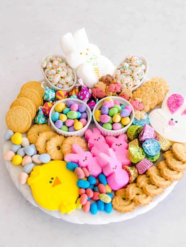 A pastel Easter candy charcuterie board idea from Fantabulosity with cookies, and candies.