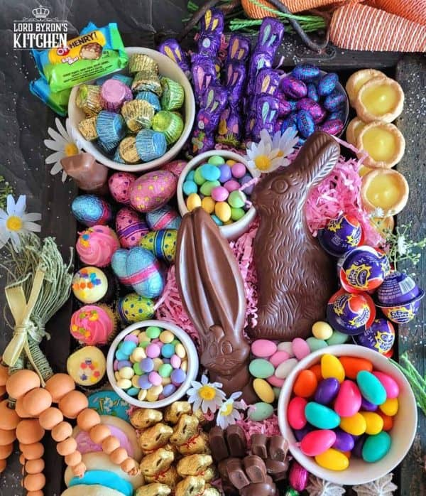 A bright and bold Easter candy charcuterie board idea from Lord Byron's Kitchen with chocolate bunnies, peanut butter cups, and other sweet goodies. 