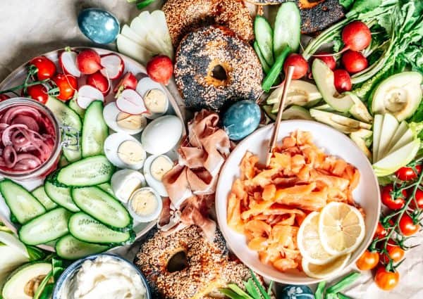 An Easter brunch charcuterie board from Chili and Tonic that includes avocados, hard boiled eggs, and bagels.