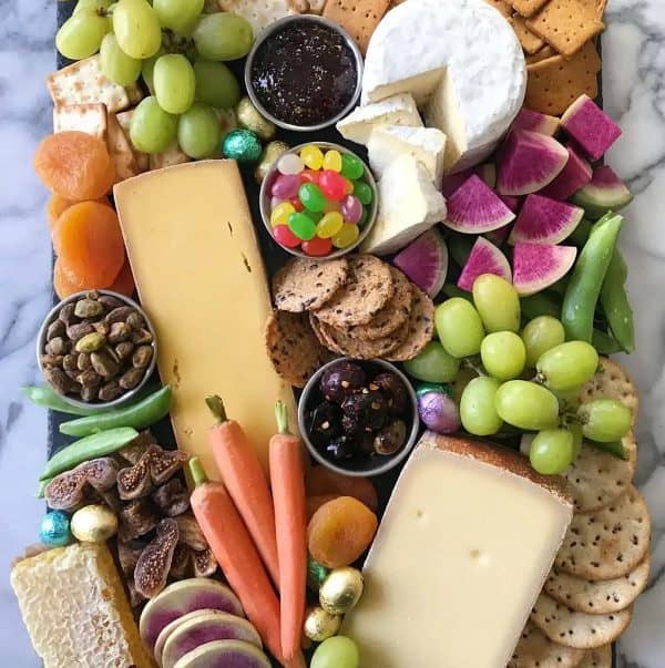 Easter charcuterie board ideas from healthy gluten-free family includes a variety of cheeses, watermelon radishes, jelly beans and more.
