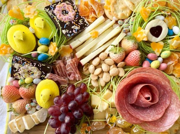 A completely edible Easter charcuterie board idea from Krazy kitchen mom that includes a variety of Easter candy, and snacks.