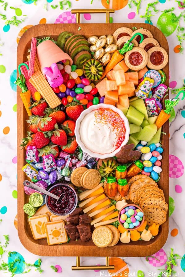 Easter charcuterie board ideas from Melissa's southern style kitchen who makes a dessert board with fruit dip and candies.