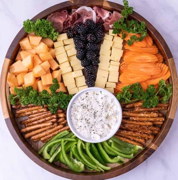 Easter charcuterie board ideas from smack of flavor that includes a simple layout with a variety of food choices.