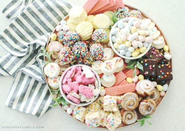 Easter charcuterie board ideas from Somewhat simple that is a dessert board including brownies, cookies, cinnamon buns and more.