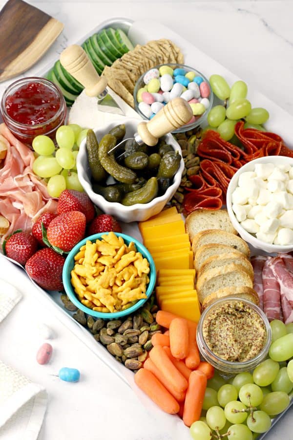 Easter charcuterie board ideas from the toasty kitchen. A board with the average options of fruit, veggies, meat, cheese, and some sweet treats.