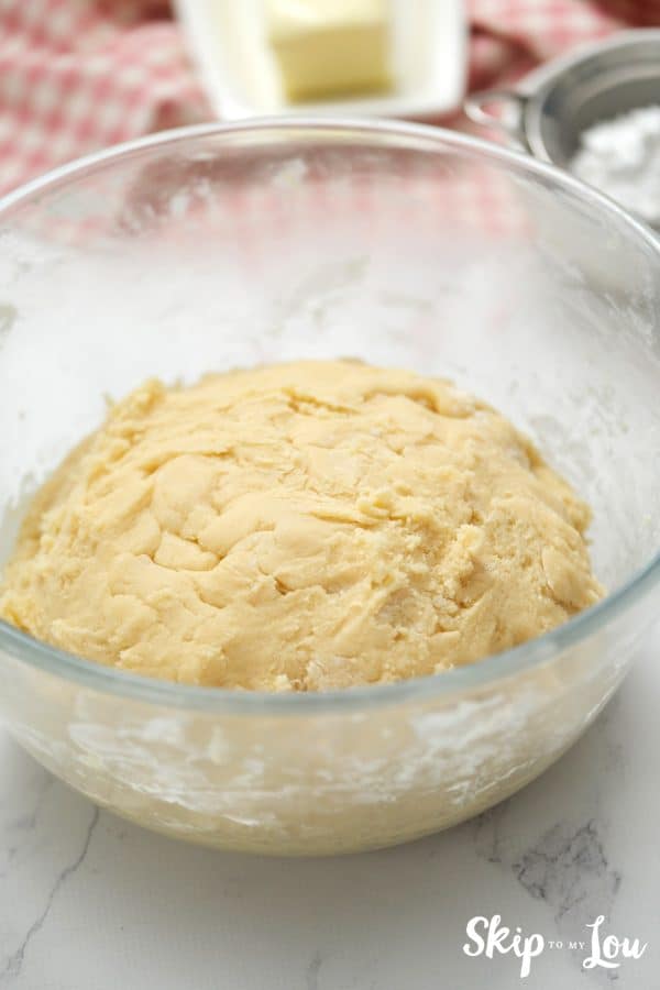 Glass mixing bowl with sugar cookie dough inside, by Skip to my Lou.