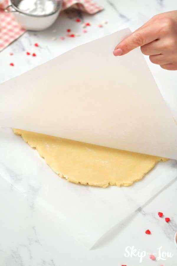 2 sheets of Parchment paper with a slab of rolled out cookie between them, by Skip to my Lou.