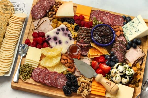 A tradition charcuterie board with some unique elements like dried pineapple, and multple types of salami from Favorite Family recipes.