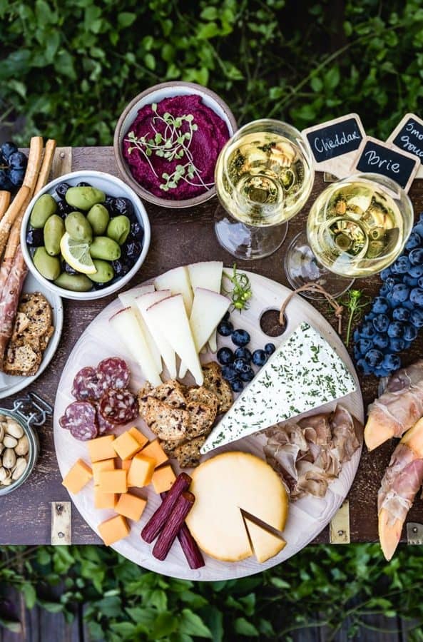 A meat charcuterie board idea for two pairs with two glasses of wine from foolproof living.