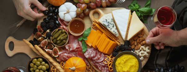 S. Clyde Weaver's meat charcuterie board with four types of cheese, meat, and some sauces for dipping.
