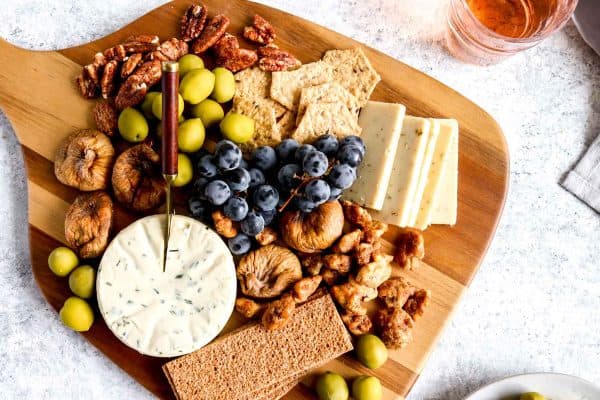 Darn Good Veggies vegetarian charcuterie board with cheese, blueberries, and crackers.