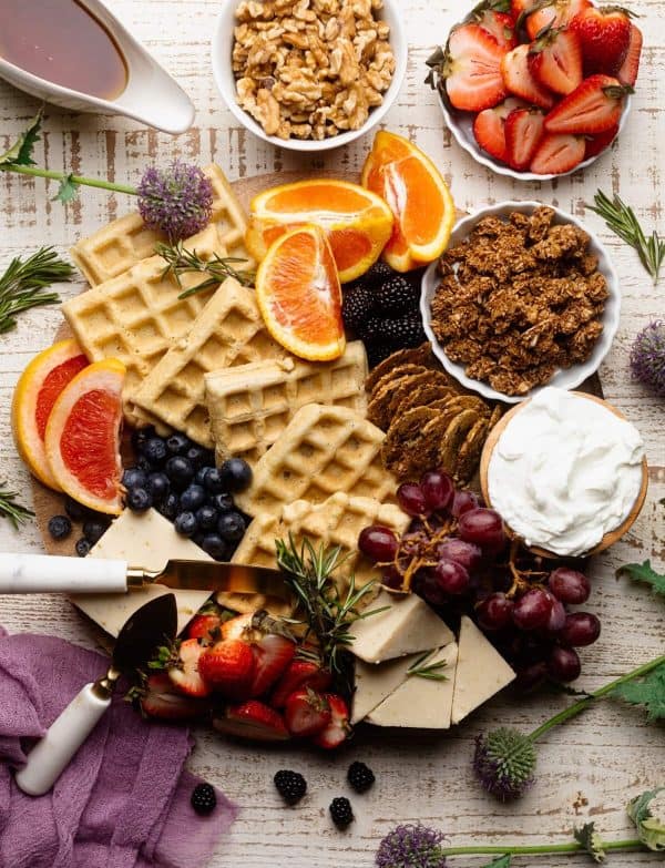 brunch board, orchids and sweet tea. a board with waffles, granola, and fruit. 
