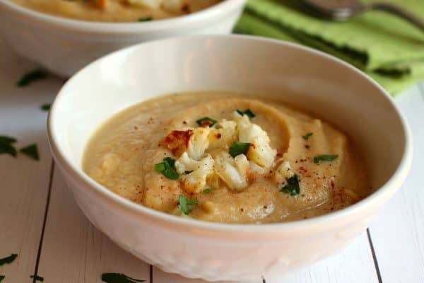 Cauliflower soup garnished with roasted cauliflower and parsley, by Skip to my Lou.