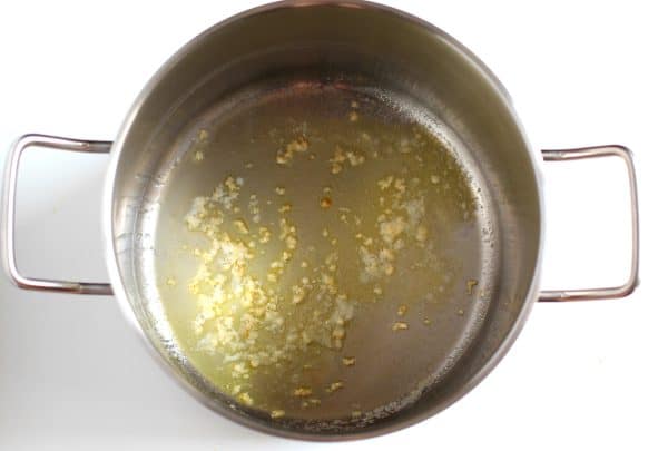 In a silver soup pot, melted butter and minced garlic cooking, by Skip to my Lou.