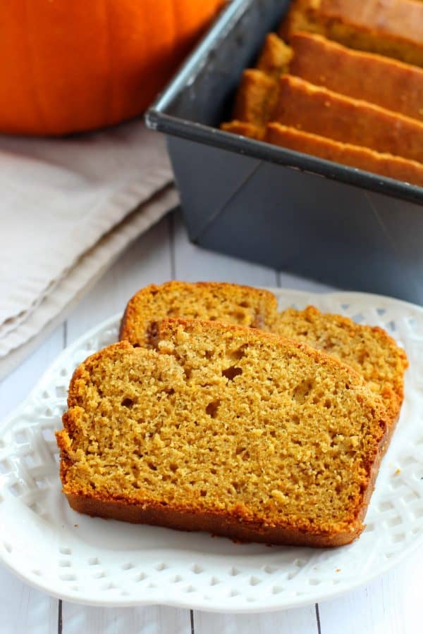 Two slices of gluten free pumpkin banana bread on a white plate, by Skip to my Lou.