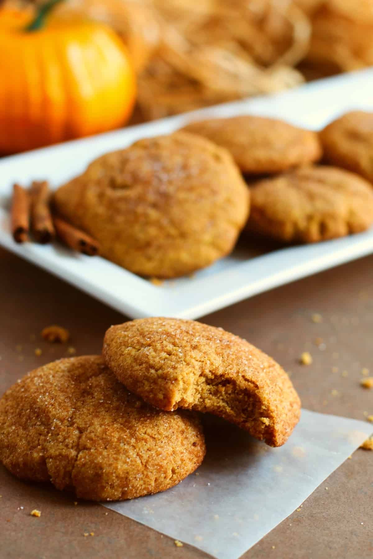 Pumpkin cookies, one with a bite taken out of it, by Skip to my Lou.