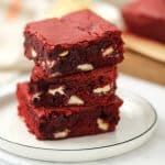 red velvet brownies stacked on a white plate