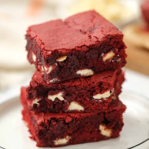 red velvet brownies stacked on a white plate