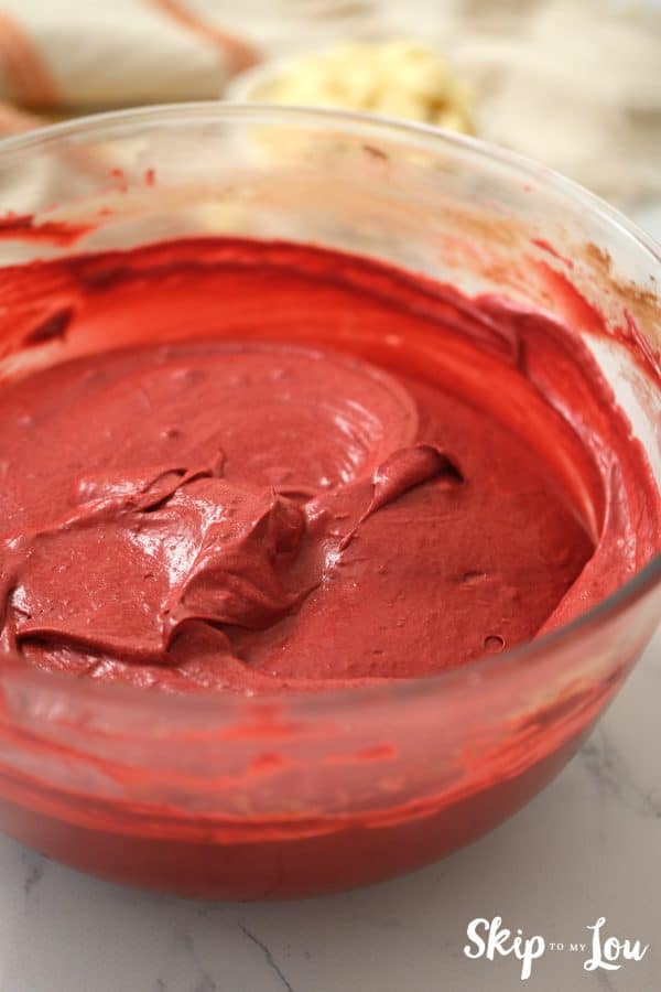 Glass mixing bowl with Red Velvet brownie mix inside, by Skip to my Lou.