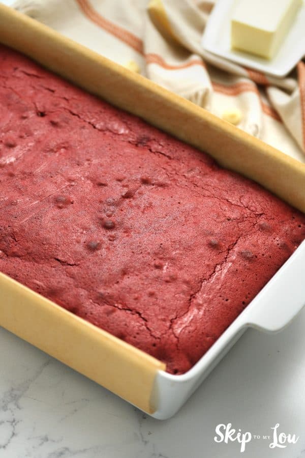 Parchment lined baking pan with a Red Velvet Brownie inside, by Skip to my Lou.