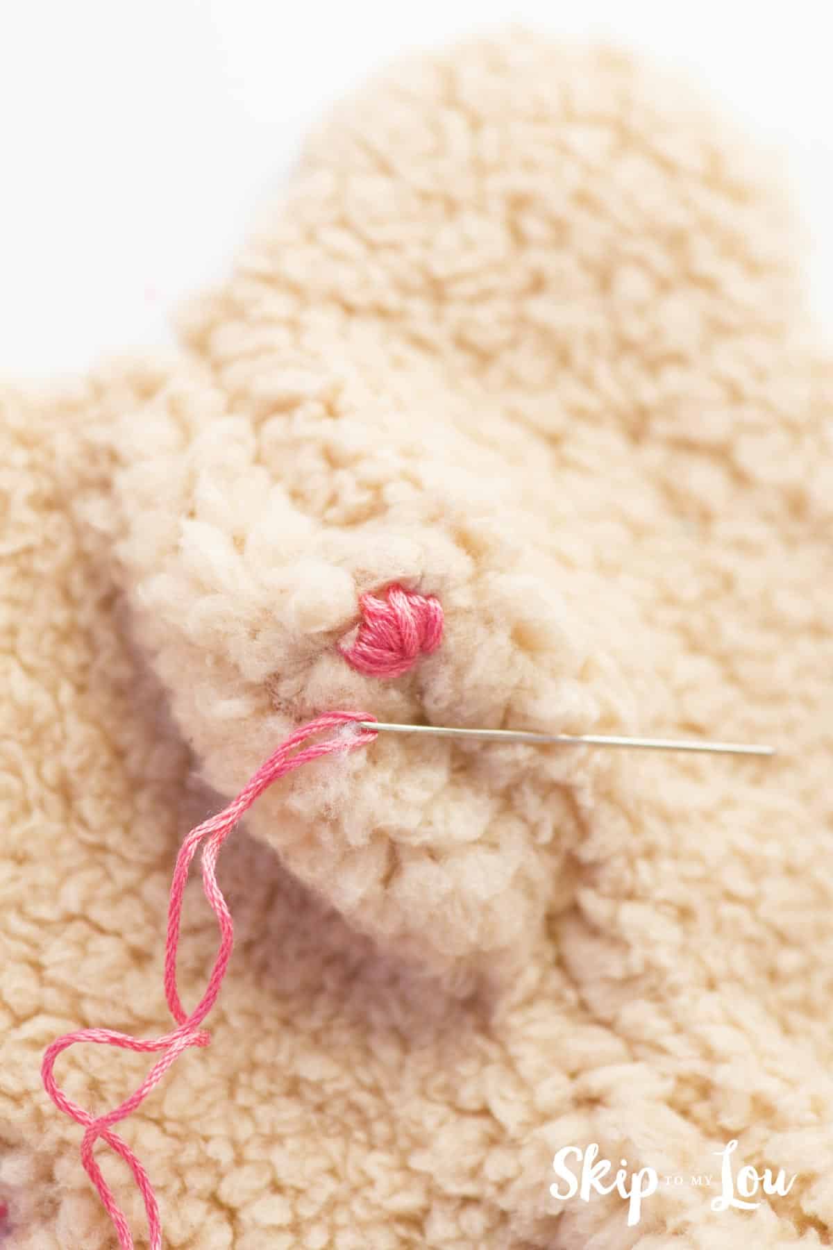 add nose to bear with embroidery floss