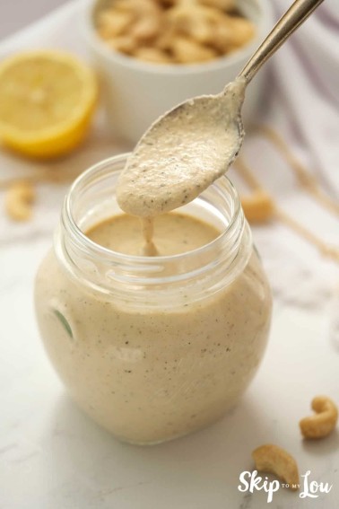 Dairy free creamy Italian salad dressing in a glass jar, by Skip to my Lou.
