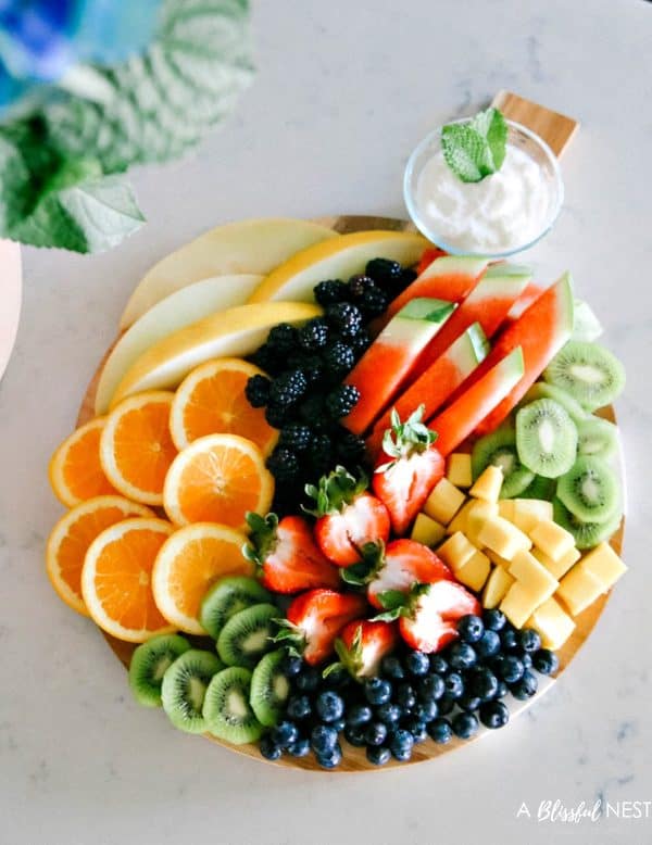 fruit charcuterie board ideas-a blissful nest-board with a variety of fruits like oranges, watermelon. blueberries and pears.
