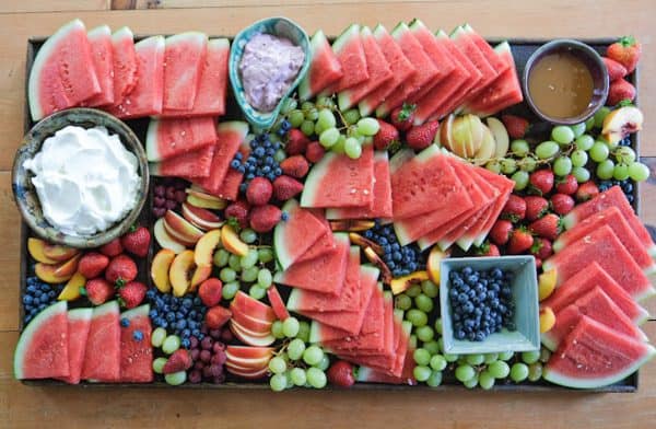 fruit charcuterie board ideas-amazing charcuterie boards-board with a watermelon, grapes, and berries.