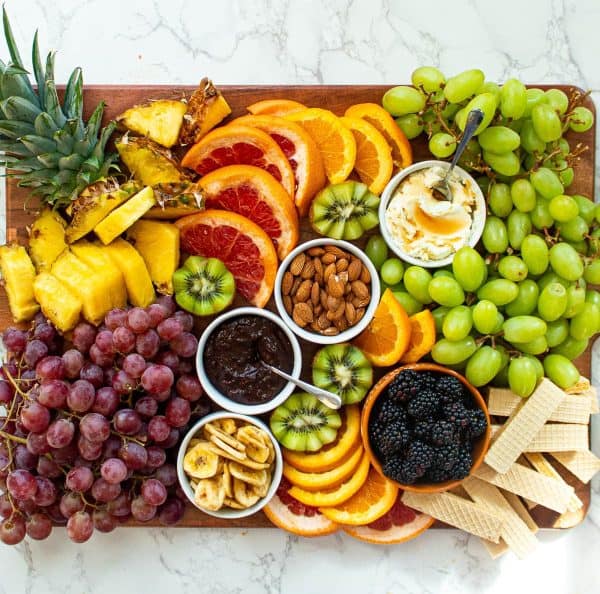 fruit charcuterie board ideas-chenee today-board with a variety of fruits and dips in the middle